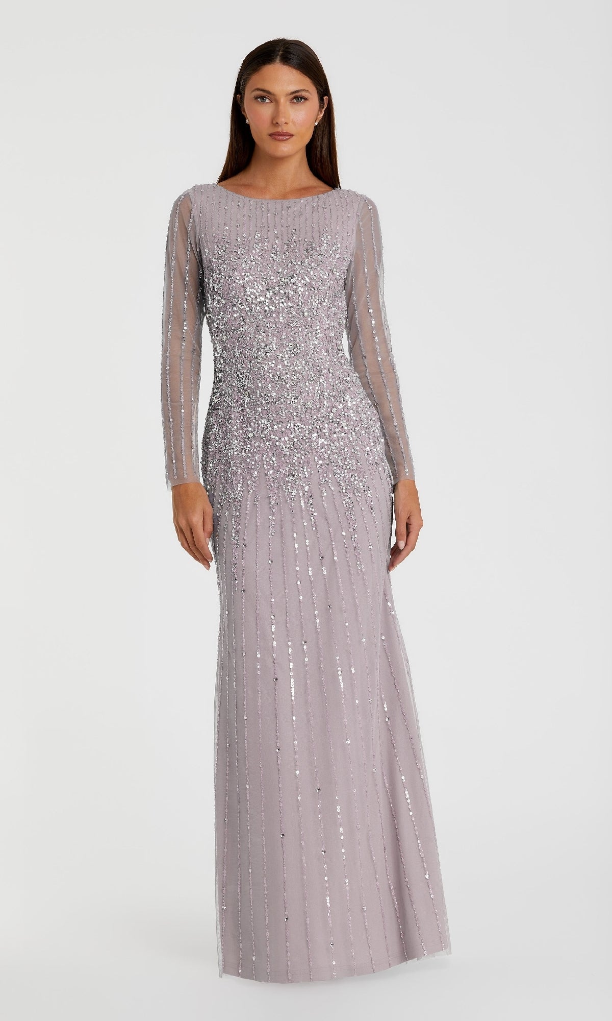 A woman models the Mac Duggal 9226 Long Sleeve Sequin Formal Gown, a floor-length light purple dress with shimmering sequins, against a plain white background.